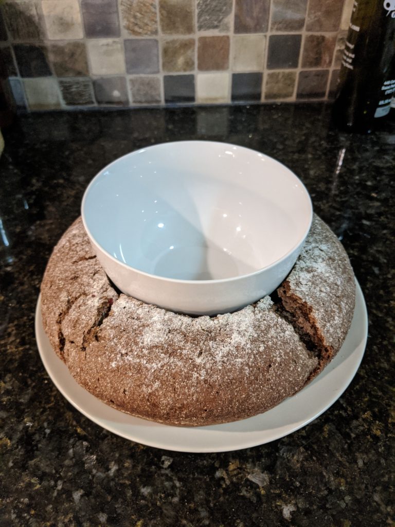 Pumpernickel bread holding a bowl for dip