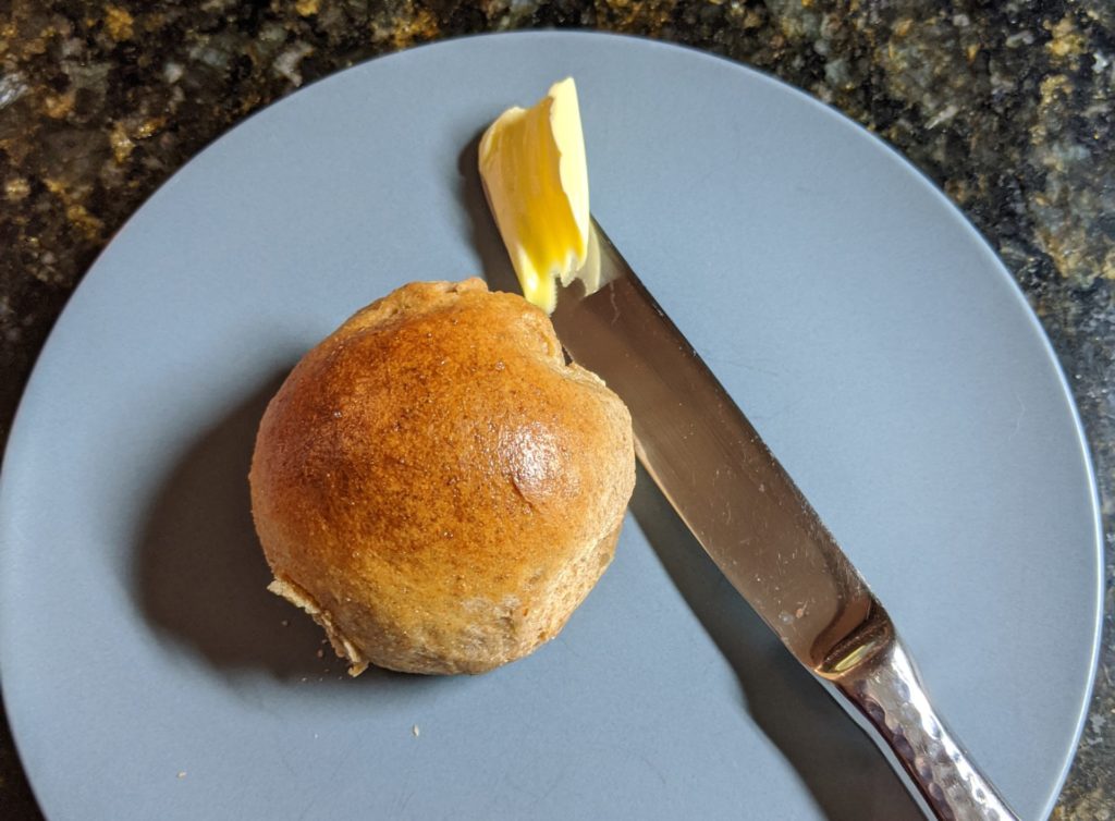 Spelt rolls with butter knife for scale