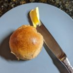 Spelt rolls with butter knife for scale