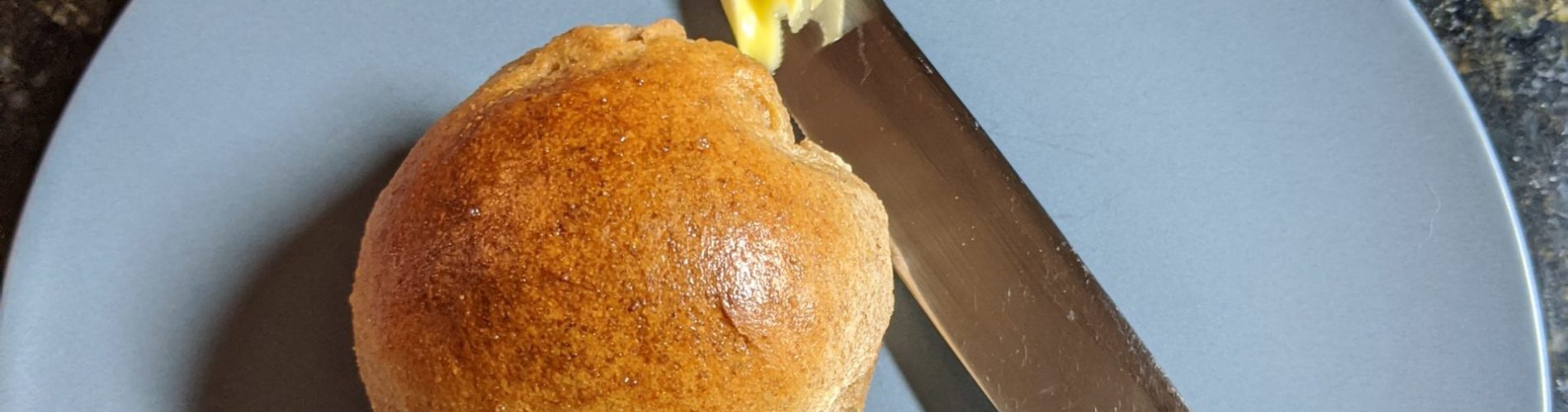 Spelt rolls with butter knife for scale